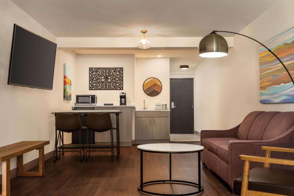 a living room with a couch and a table at Radisson Hotel Colorado Springs Airport in Colorado Springs