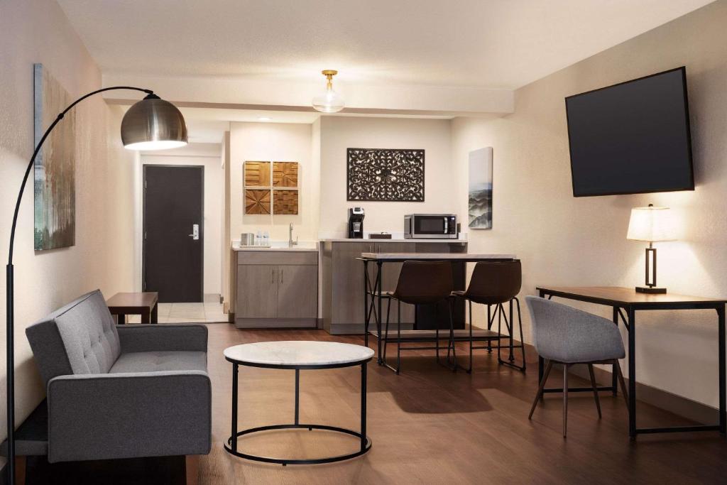 a living room with a couch and chairs and a table at Radisson Hotel Colorado Springs Airport in Colorado Springs