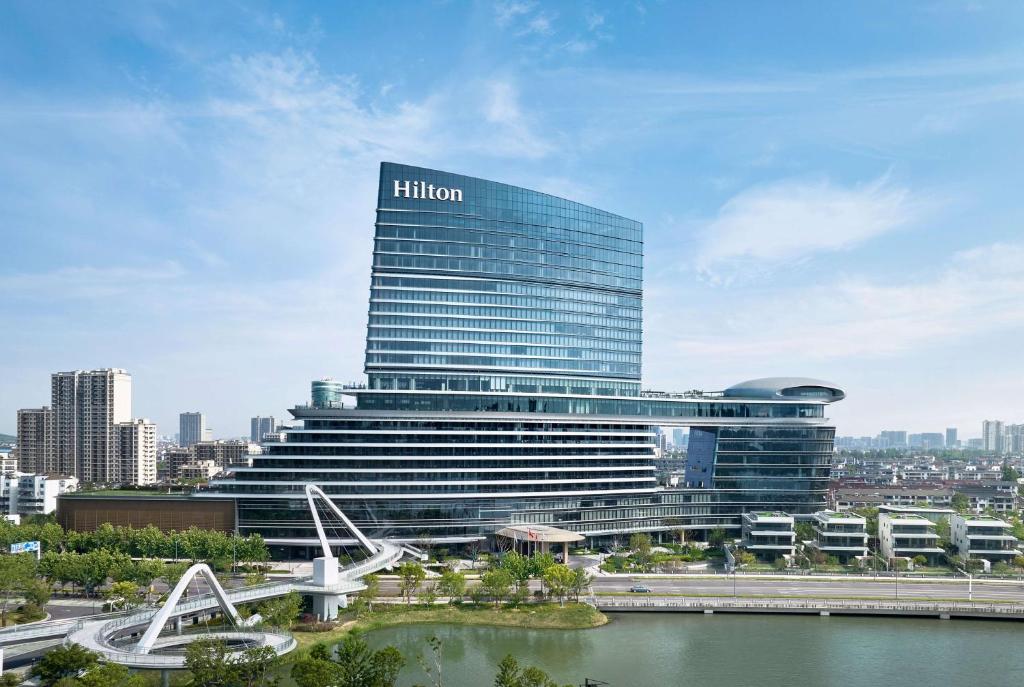 a building with a hilton sign on top of it at Hilton Changshu in Changshu