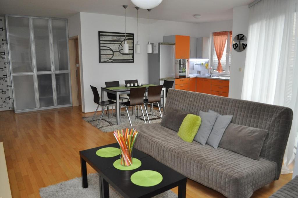 a living room with a couch and a table at Alexandar's Place Apartment in Skopje