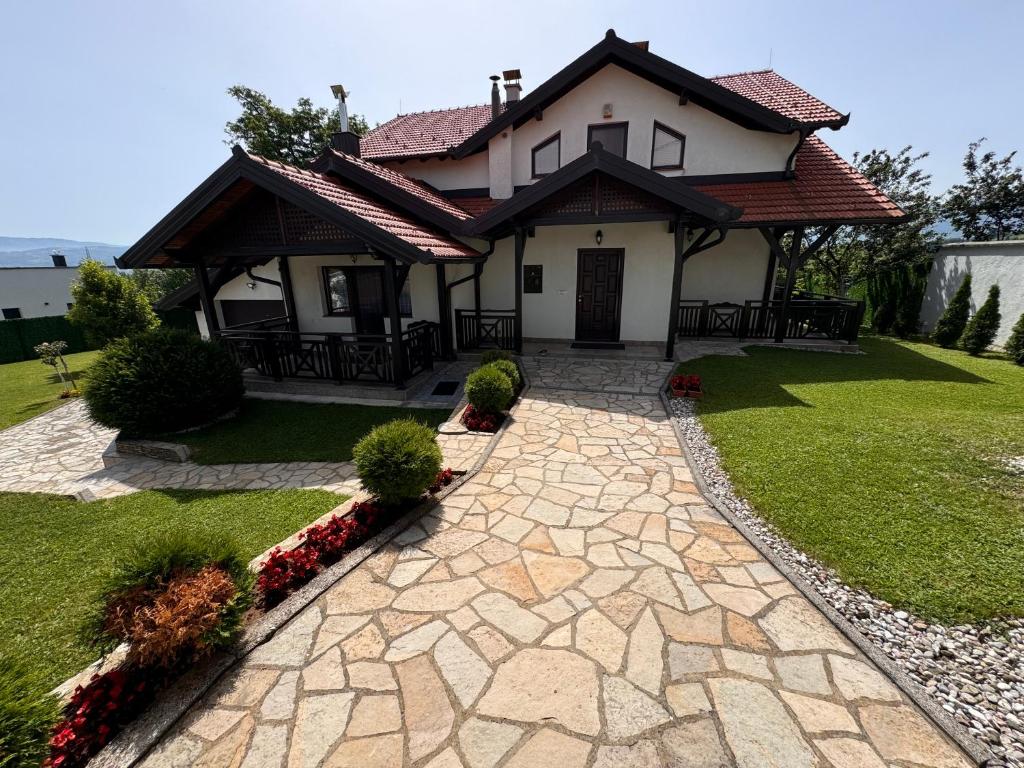 a house with a stone walkway in front of it at Sarajevo Villa Ruza Vjetrova in Vinogradi