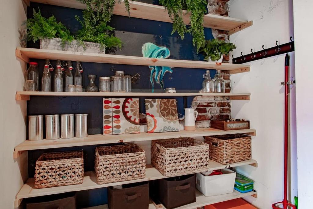 a room with shelves with baskets and plants at Inviting 3-Lvl DC Townhome Walk to METRO Station & Union Market H Street NoMa Union Station in Washington, D.C.