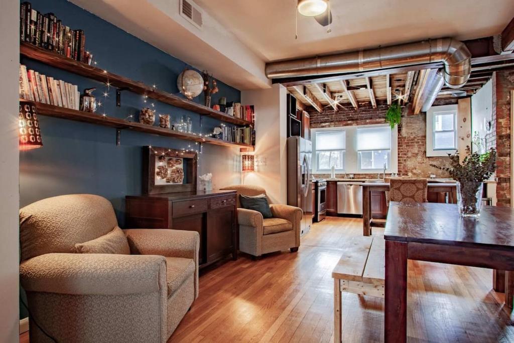a living room with a table and chairs and a kitchen at Inviting 3-Lvl DC Townhome Walk to METRO Station & Union Market H Street NoMa Union Station in Washington, D.C.