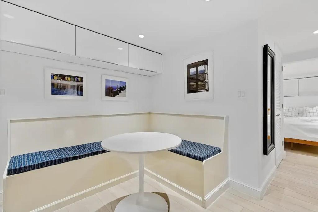a white room with a table and a bed at Heart Of Dupont and Walk to Georgetown in Washington, D.C.