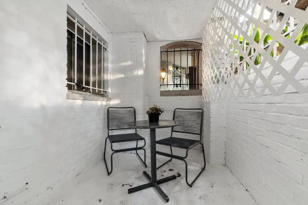 a table and two chairs in a white room at Heart Of Dupont and Walk to Georgetown in Washington, D.C.