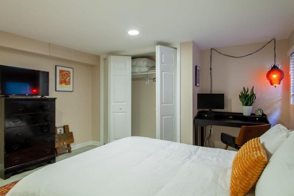 a bedroom with a large white bed and a desk at 2-BR City Retreat Peace Privacy & Parking in Washington, D.C.
