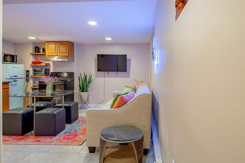 a living room with a couch and a table at 2-BR City Retreat Peace Privacy & Parking in Washington, D.C.