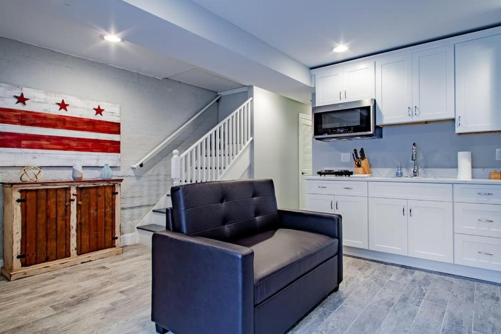 a living room with a chair and an american flag on the wall at Central DC Flat Sleeps 3 Convention Center in Washington, D.C.