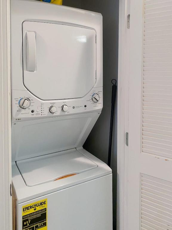 a white refrigerator with a tv on top of it at Central DC Flat Sleeps 3 Convention Center in Washington, D.C.