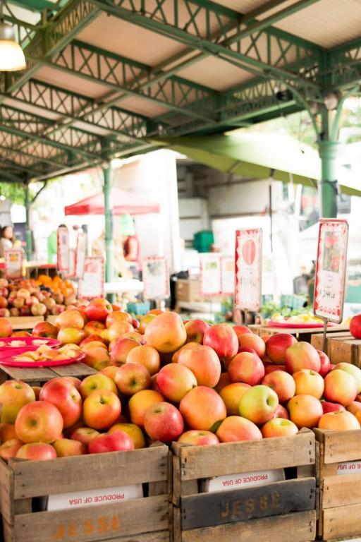 a bunch of apples in boxes in a market at Barracks Row & Eastern Market Oasis Transit-Friendly in Washington, D.C.