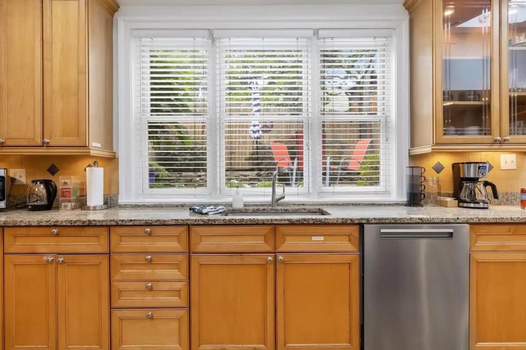 a kitchen with a sink and a window at Historic & Modern Capitol Hill 2-BR Row Home in Washington, D.C.