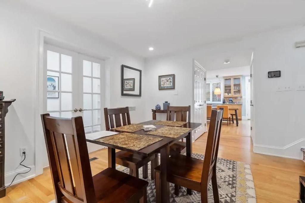 a dining room and living room with a table and chairs at Historic & Modern Capitol Hill 2-BR Row Home in Washington, D.C.
