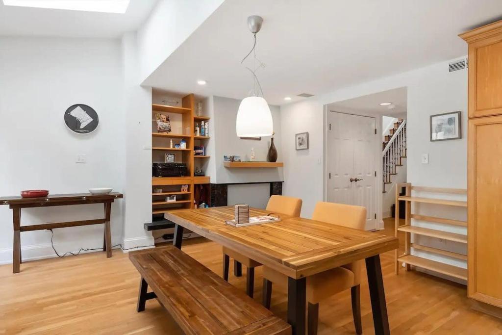 a dining room with a wooden table and chairs at Historic & Modern Capitol Hill 2-BR Row Home in Washington, D.C.