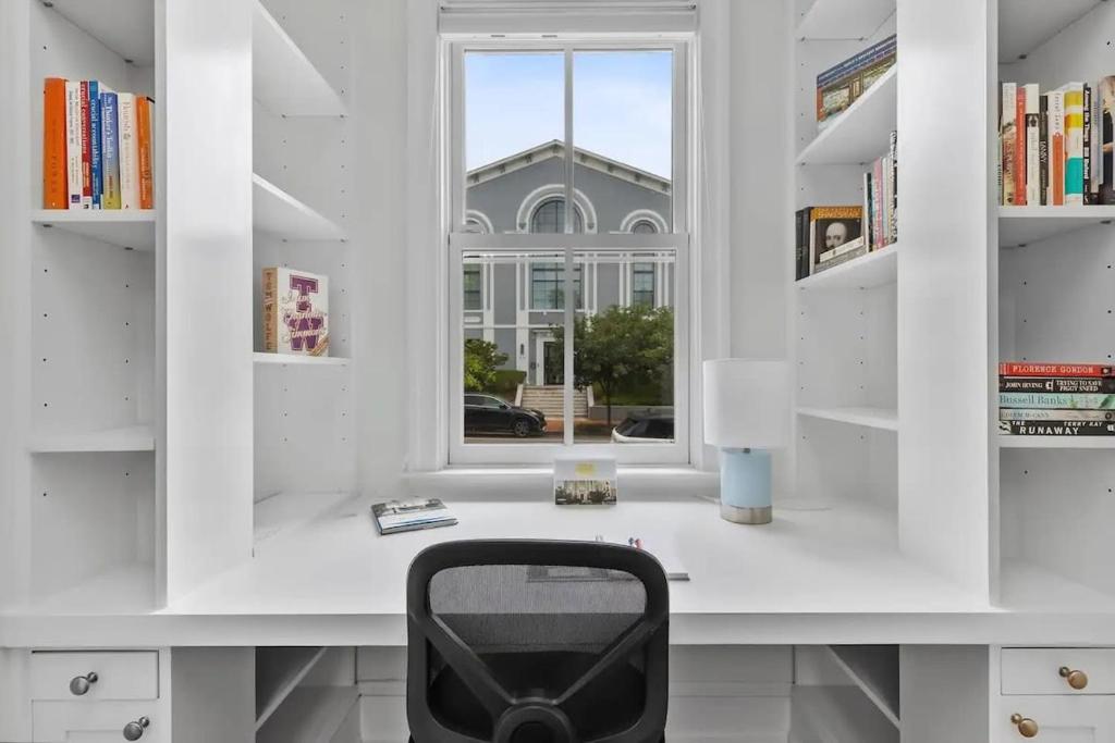 a white room with a desk and a window at Historic & Modern Capitol Hill 2-BR Row Home in Washington, D.C.
