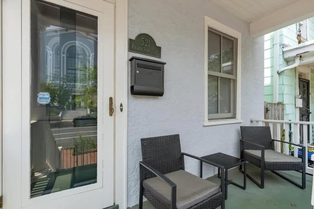 two chairs and a table on a porch at Historic & Modern Capitol Hill 2-BR Row Home in Washington, D.C.