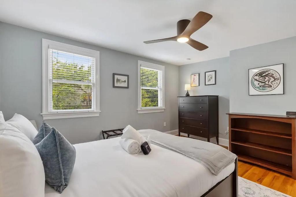 a bedroom with a bed and a ceiling fan at Historic & Modern Capitol Hill 2-BR Row Home in Washington, D.C.