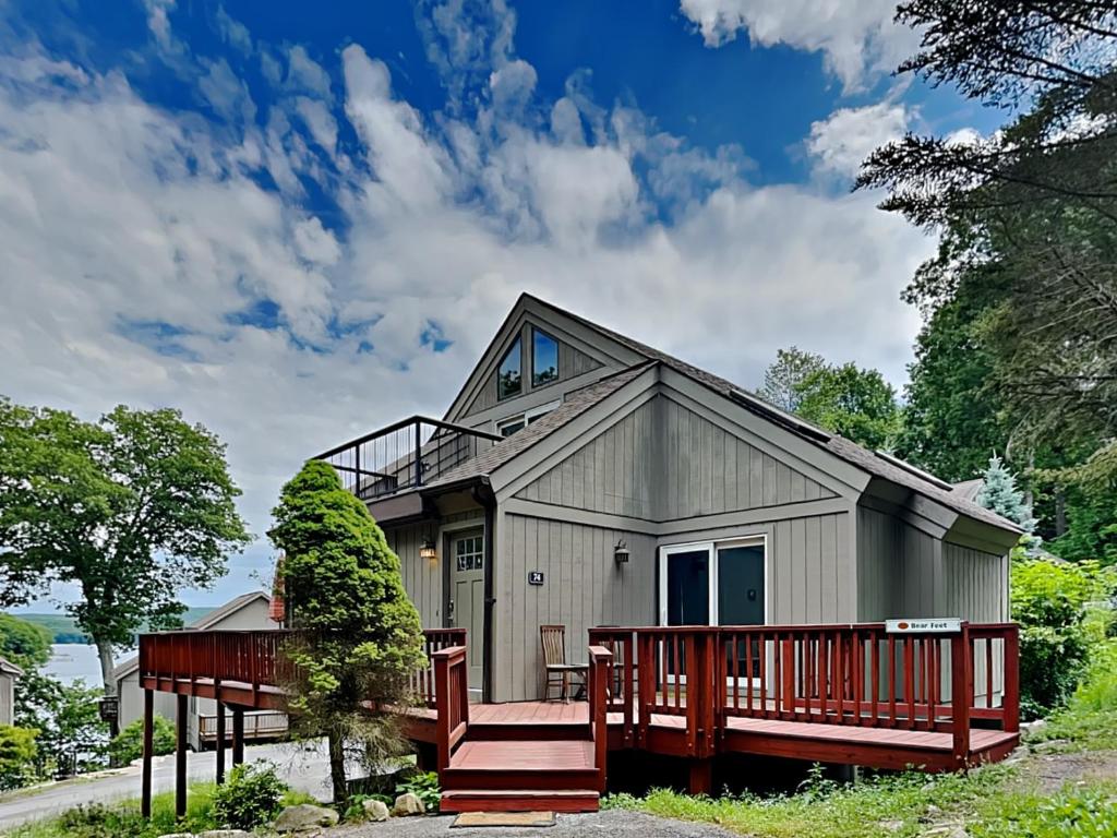 a home with a large porch and a deck at Bear Feet in Oakland