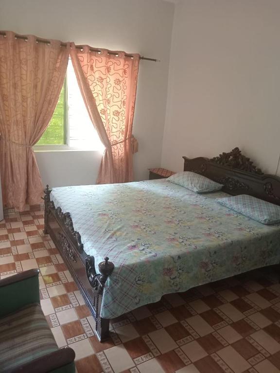 a bedroom with a large bed in front of a window at Abbasi guest house in Murree