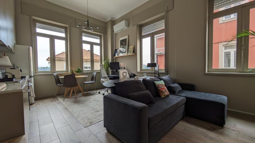a living room with a couch and a table at dvnest - Premium 1BR Apartment with River View! in Porto