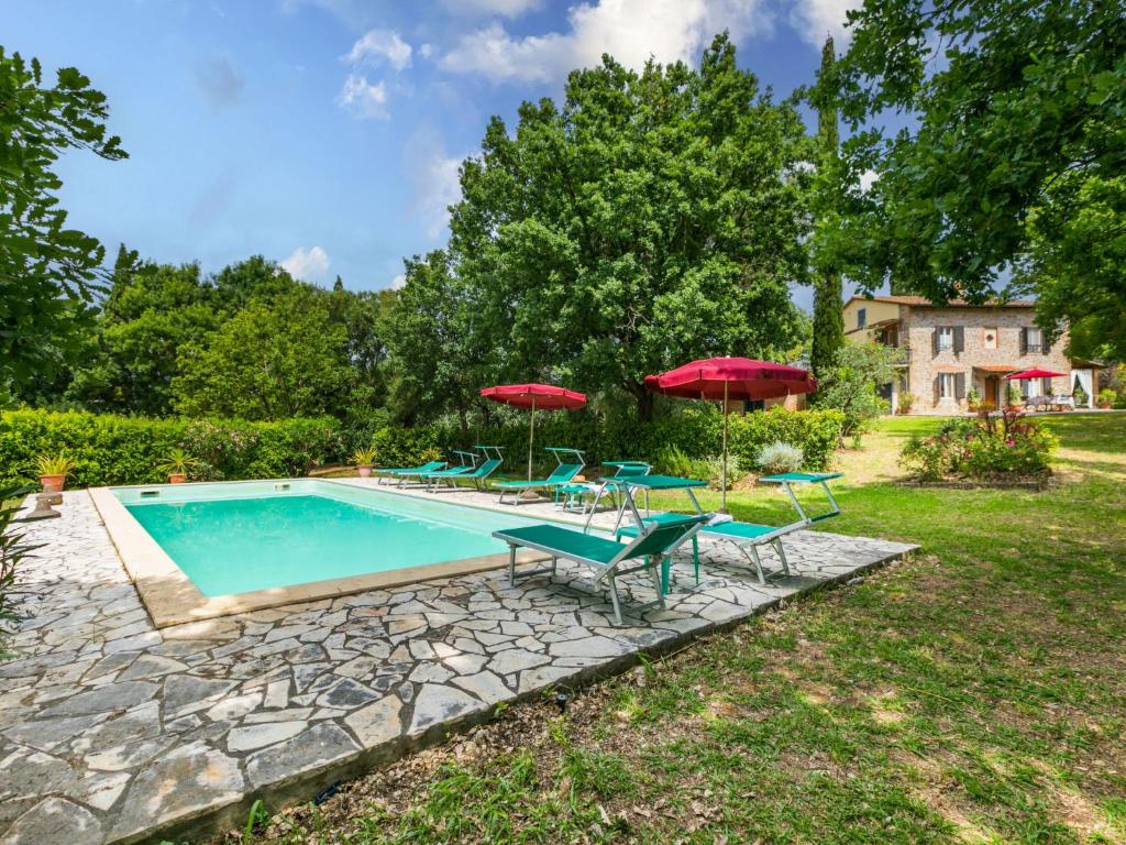 a swimming pool with patio furniture and umbrellas at Holiday Home Tenuta La Colonna by Interhome in Ponte di Masino