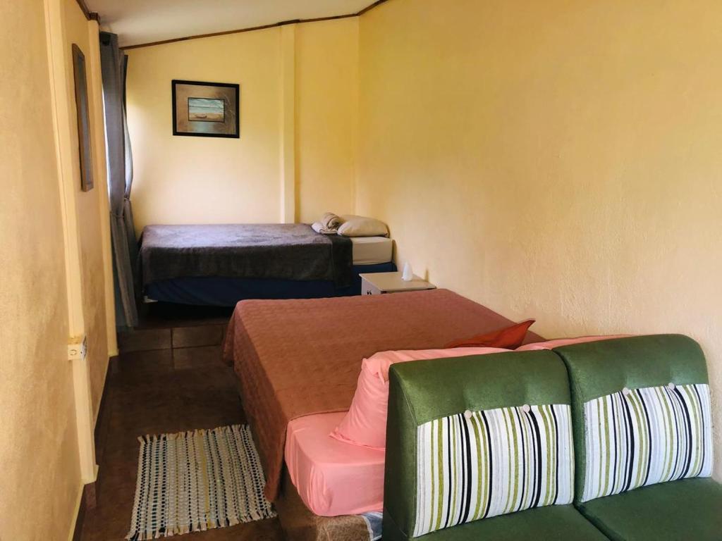 Postel nebo postele na pokoji v ubytování Hotel Cocodrilo Sierpe