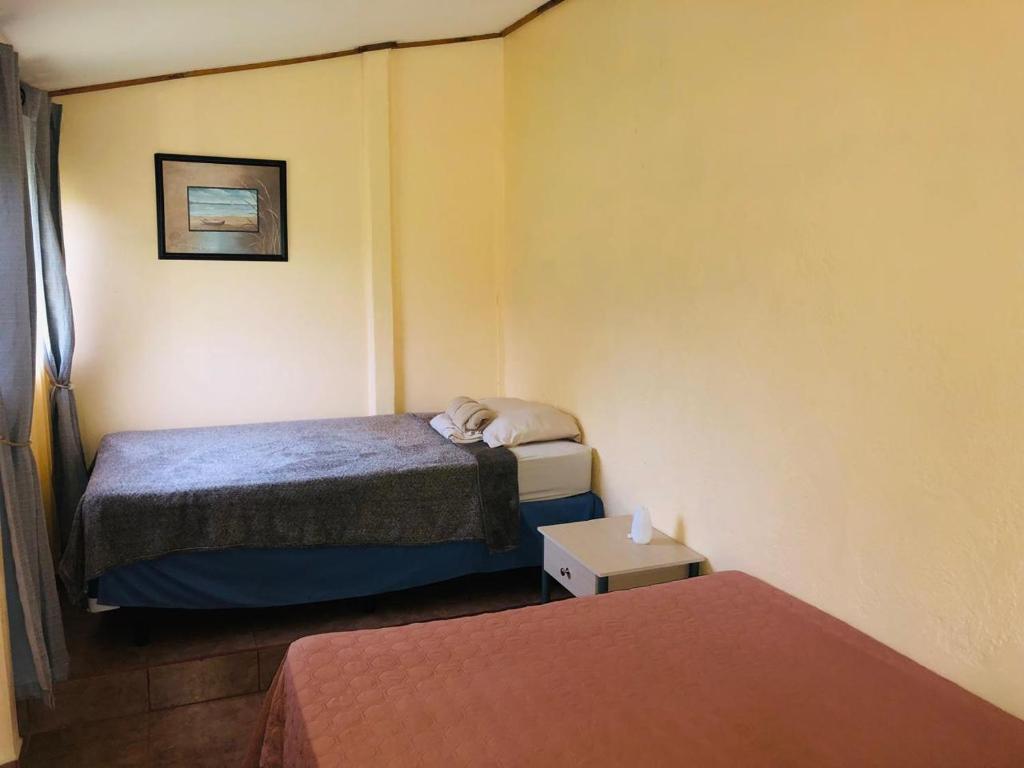 Postel nebo postele na pokoji v ubytování Hotel Cocodrilo Sierpe