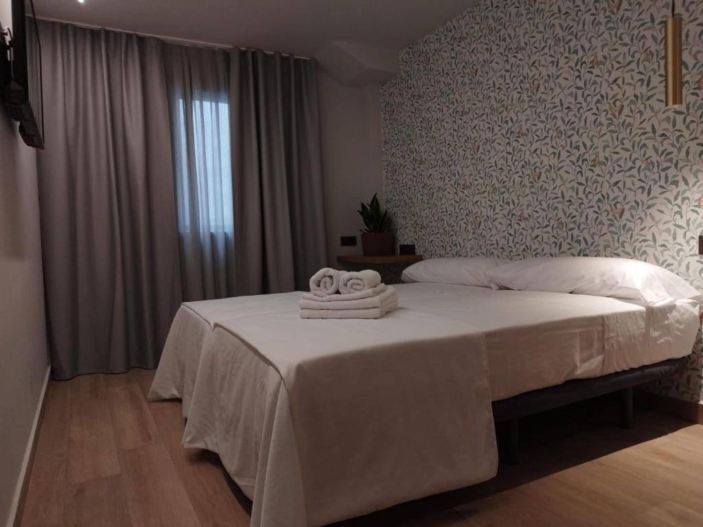 Postel nebo postele na pokoji v ubytování Plaza Rooms