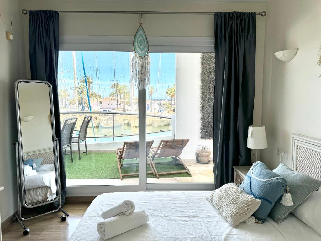 a bedroom with a bed and a view of a patio at Simply Astonishing Location in Benalmádena