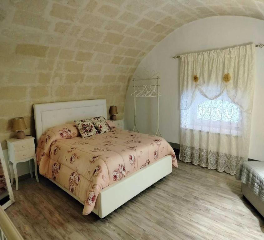 a bedroom with a bed and a window at La Chicca nel Centro in Massafra