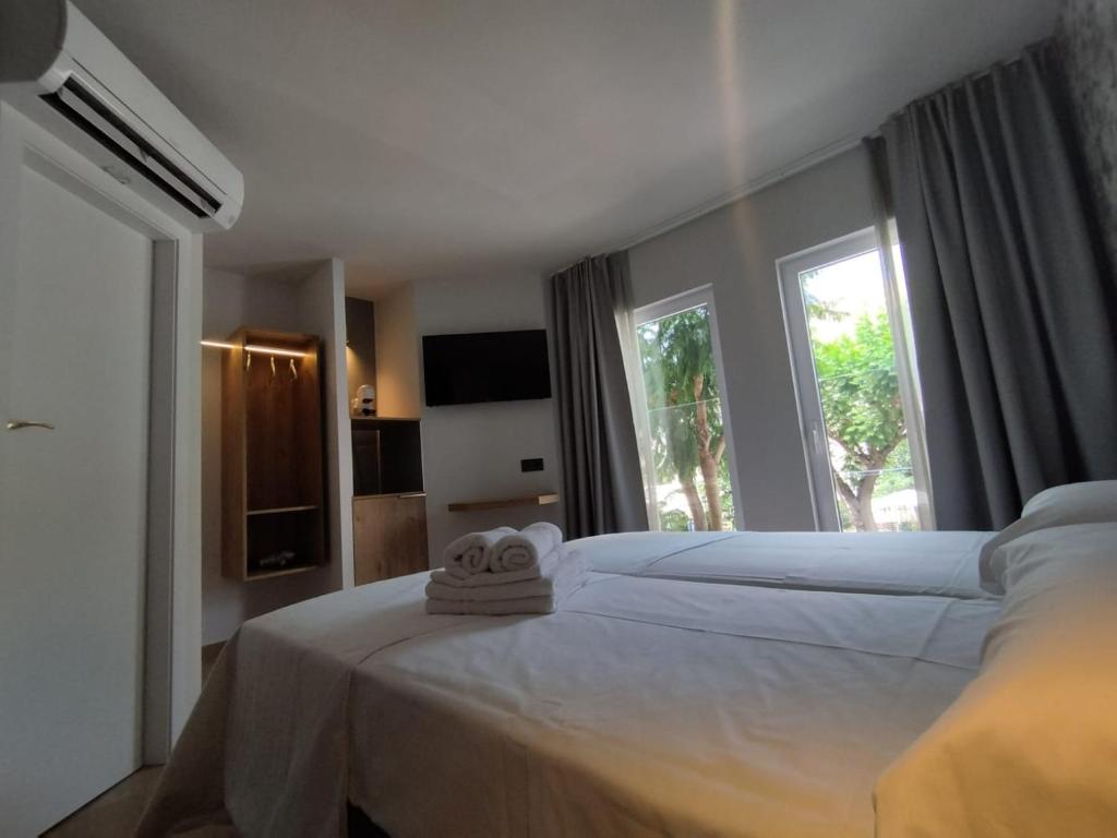 Postel nebo postele na pokoji v ubytování Plaza Rooms