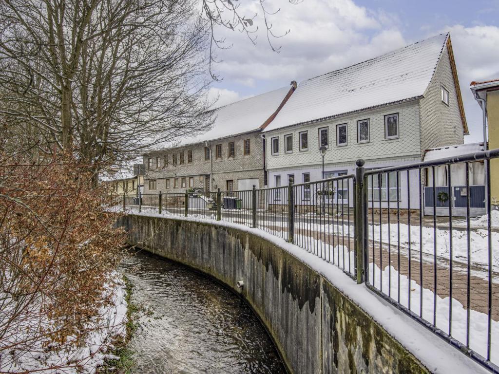 a bridge over a river next to a building at Apartment Eliese by Interhome in Suhl