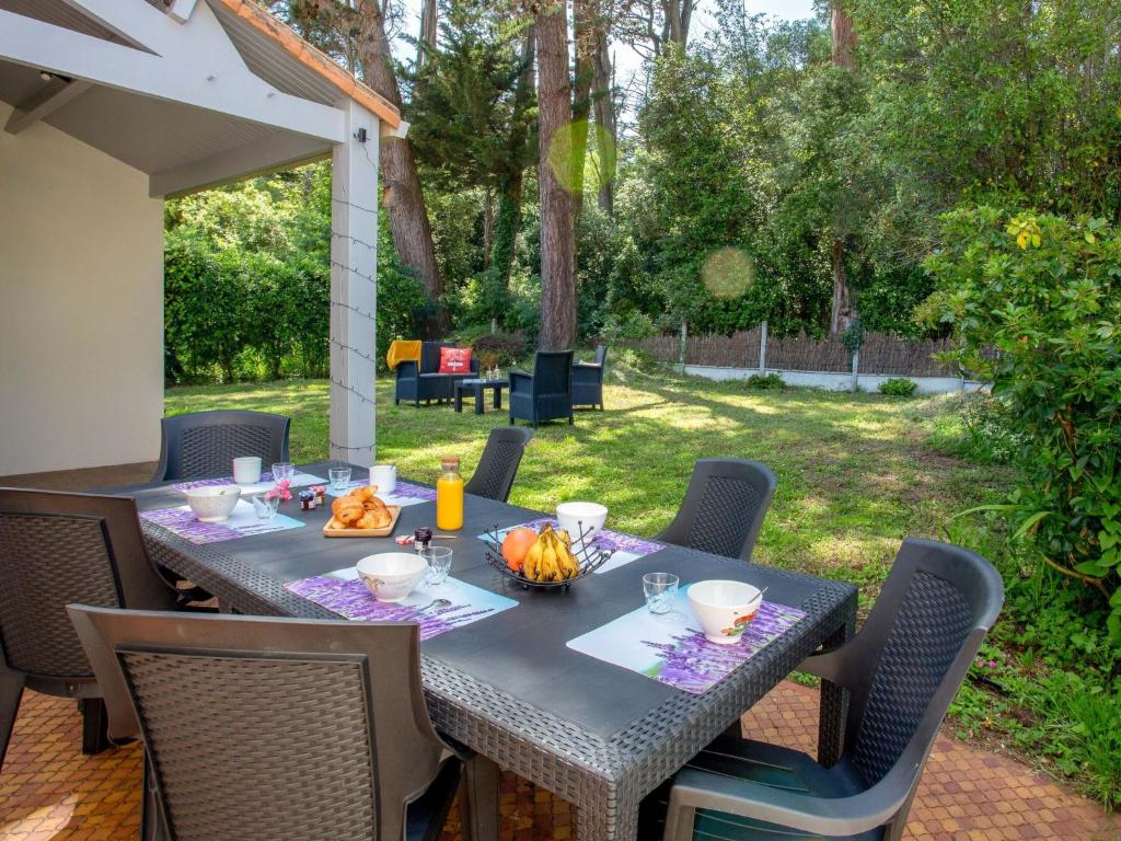 een tafel en stoelen op een patio bij Holiday Home Les Pins by Interhome in Pornic