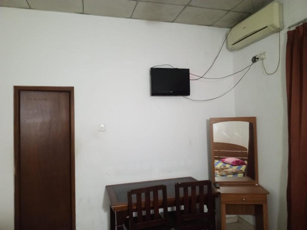 a room with a table and a mirror and a television on the wall at Hotel Friendstar in Minuwangoda