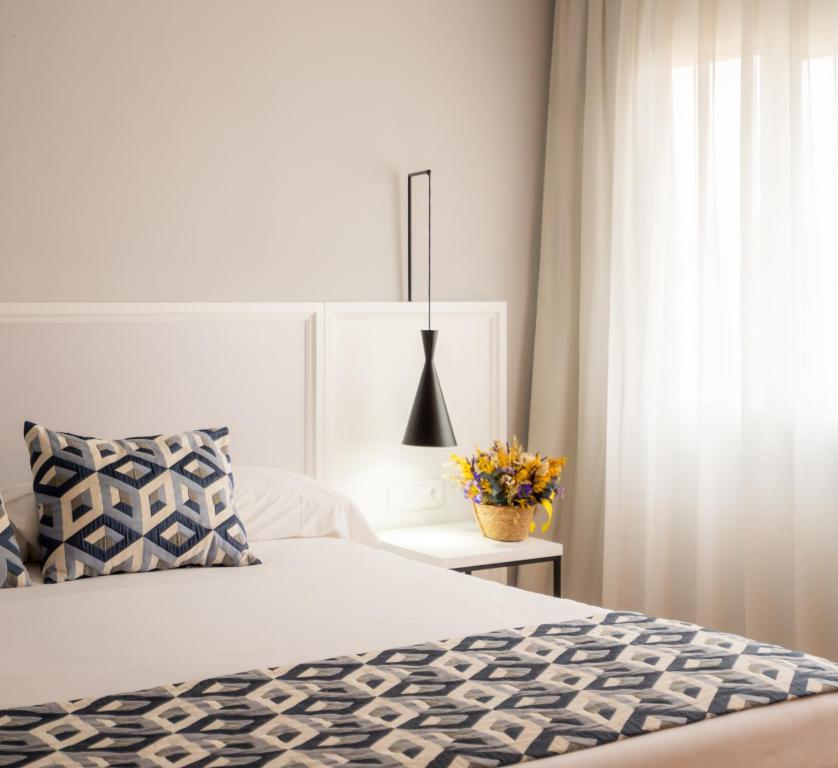 Postel nebo postele na pokoji v ubytování Hotel Beleret