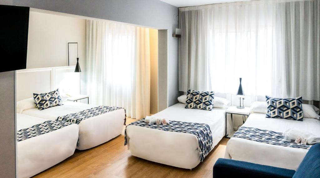 Postel nebo postele na pokoji v ubytování Hotel Beleret