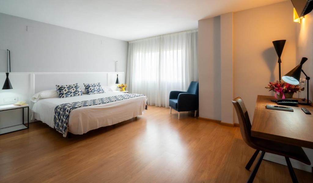 Postel nebo postele na pokoji v ubytování Hotel Beleret