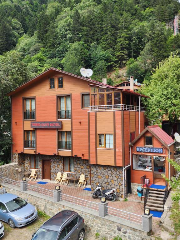 a building with cars parked in front of it at Trend Suite Hotel in Uzungöl