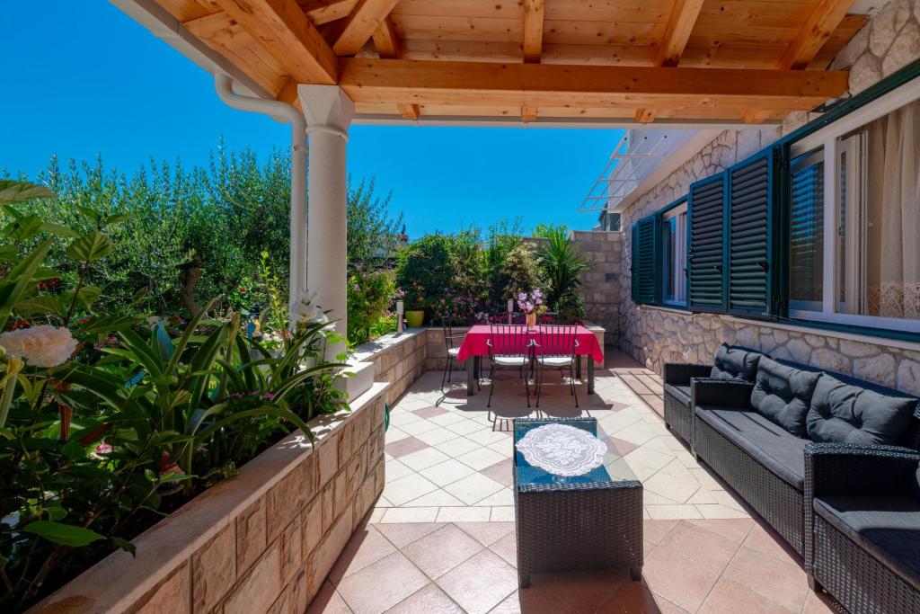 a patio with a table and a couch and a table at Apartments Maria in Dubrovnik