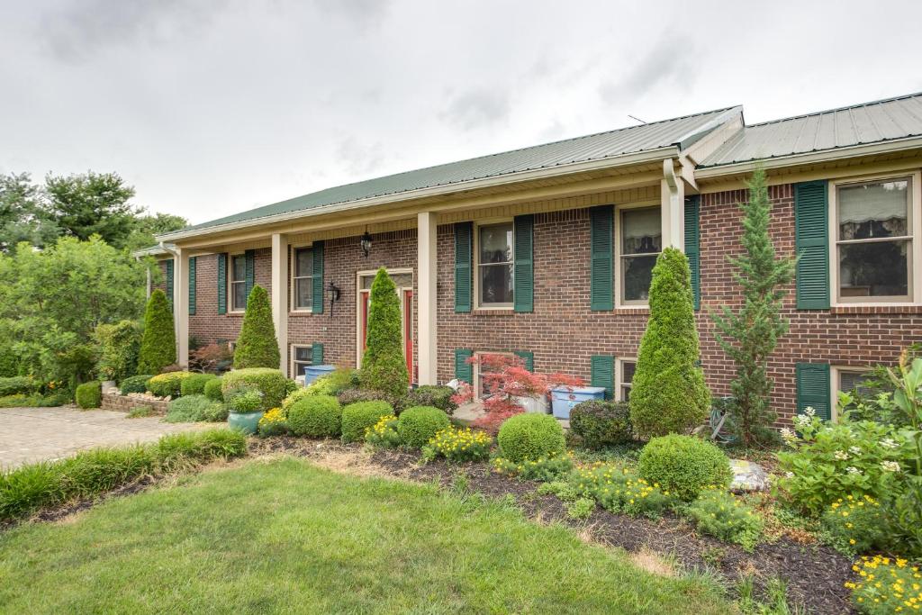 a brick house with a garden in front of it at Large and Private Guest House Apt with Patio and Views! in Danville