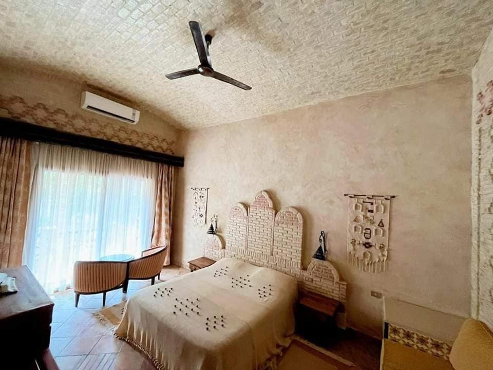 Postel nebo postele na pokoji v ubytování Dar Horchani Tozeur