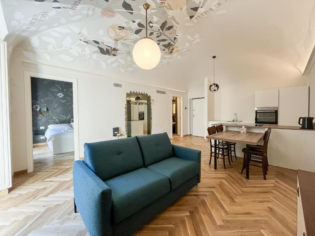 a living room with a blue couch and a table at Casa del viaggiatore in Turin