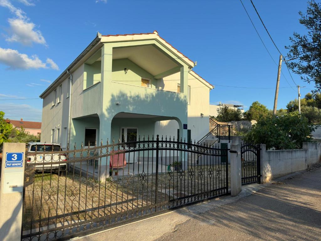 a house with a fence in front of it at Villa A&M in Vinišće