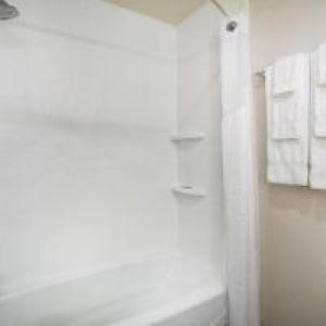 a white bathroom with a shower and a sink at Holiday Inn Express & Suites - Rapid City - Rushmore South by IHG in Rapid City