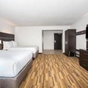a large bedroom with a bed and a wooden floor at Holiday Inn Express & Suites - Rapid City - Rushmore South by IHG in Rapid City