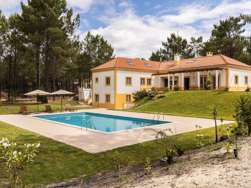 a large house with a swimming pool in the yard at Holiday Home Herdade de Montalvo- Villa 60 by Interhome in Alcácer do Sal