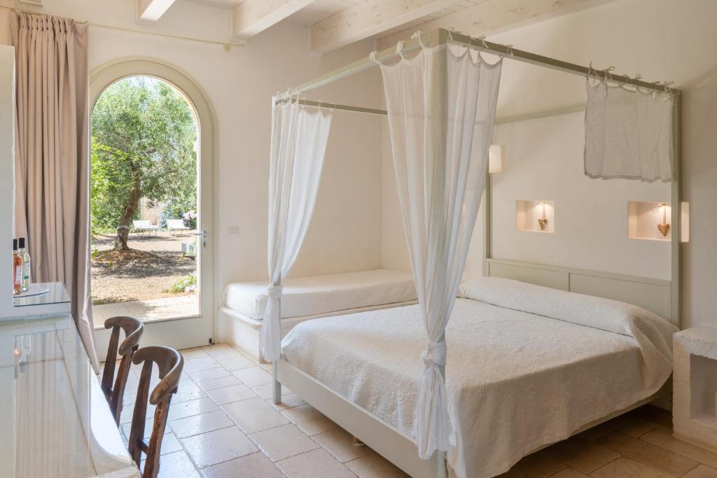 Postel nebo postele na pokoji v ubytování Masseria Agrituristica Lama San Giorgio
