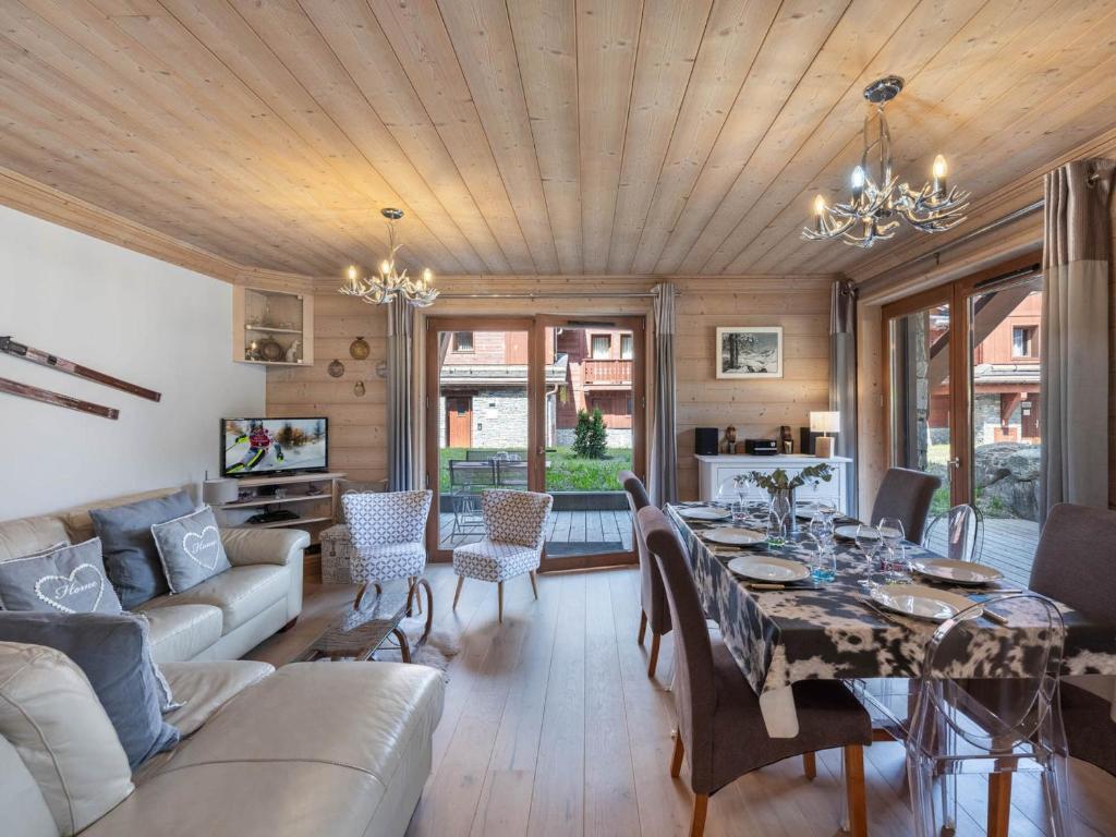 - un salon avec un plafond en bois et une table à manger dans l'établissement Appartement cosy, proche des pistes à Courchevel, 7 pers, parking, terrasse et WIFI - FR-1-563-25, à Courchevel
