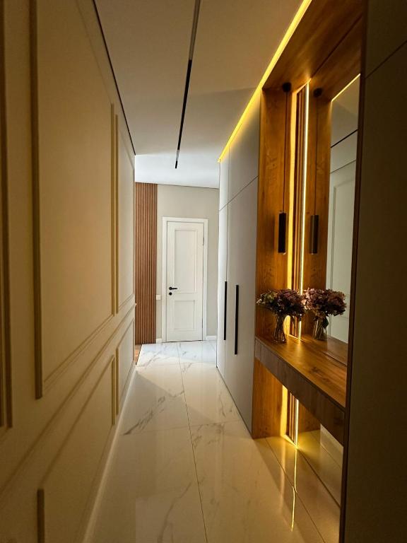 a hallway with a door and a room with a hallway at Home Side Apartment in Batumi