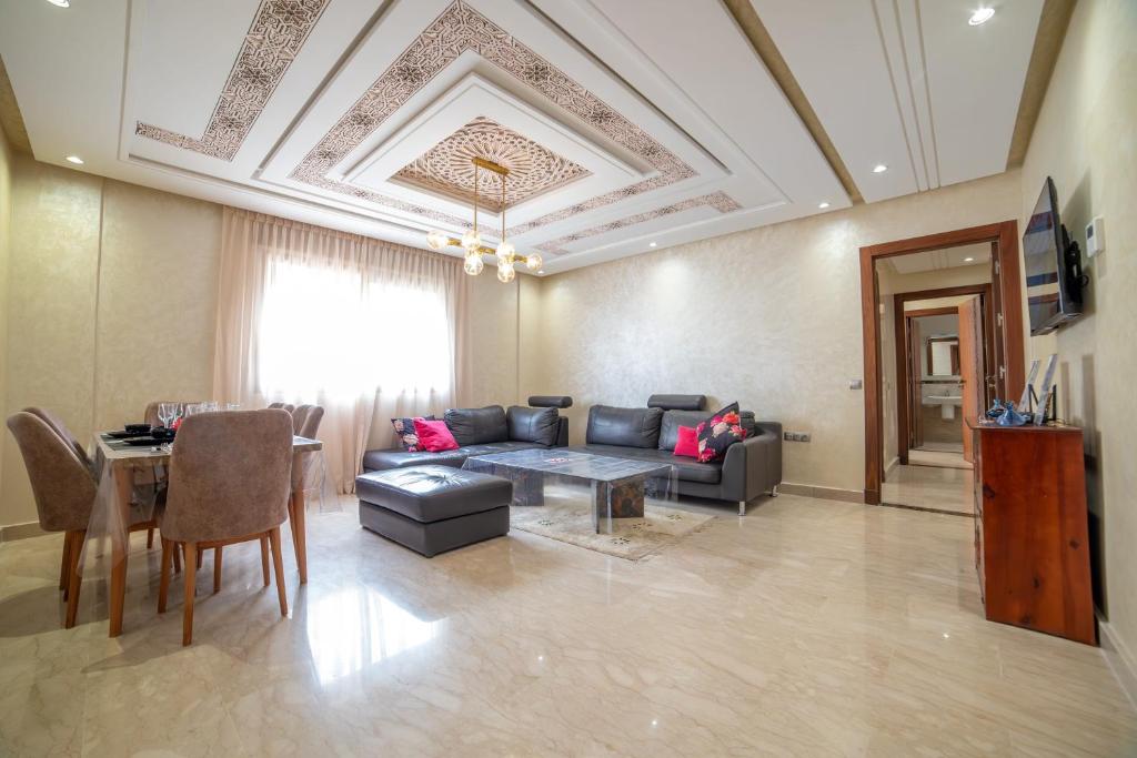 a living room with a couch and a table at Luxury Seafront Apartment 101sqm with 2 Bedrooms and Wi-Fi Unlimited in Agadir