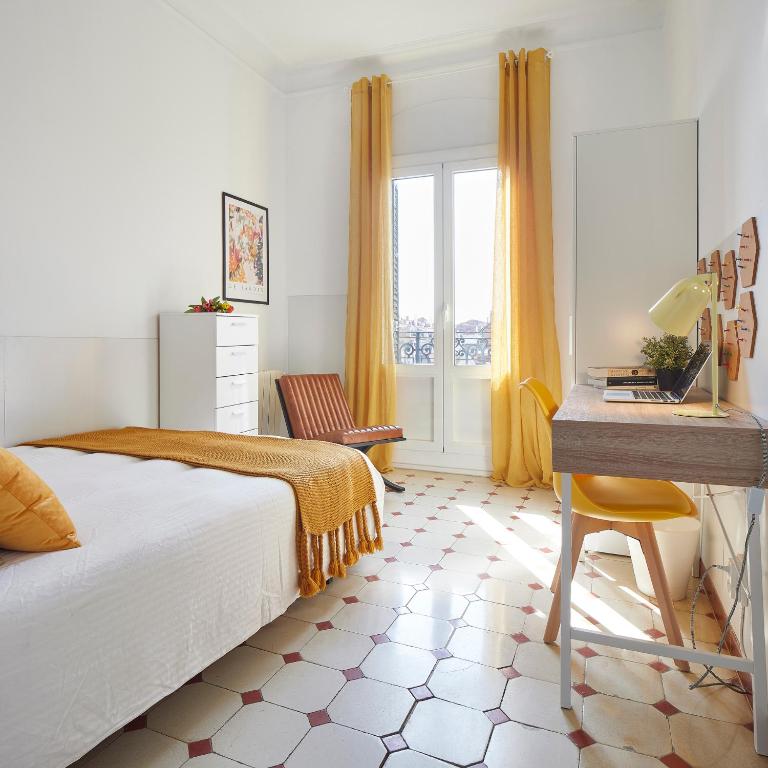 a bedroom with a bed and a desk at Gran Via - 1 in Barcelona